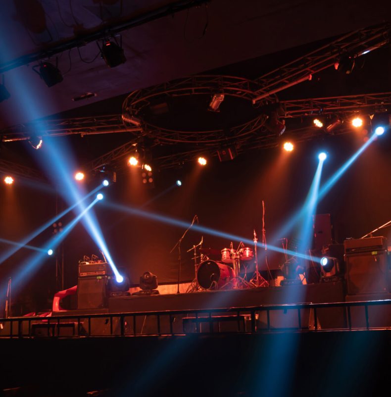 Empty stage concert with colorful lighting laser beam spotlight show in disco pub club bar background for party music dancing festival performance. Entertainment nightlife. Celebration event.